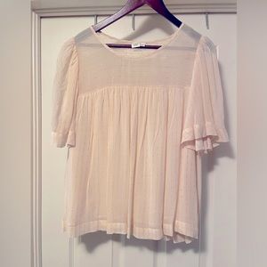 Cream blouse with gold accents.